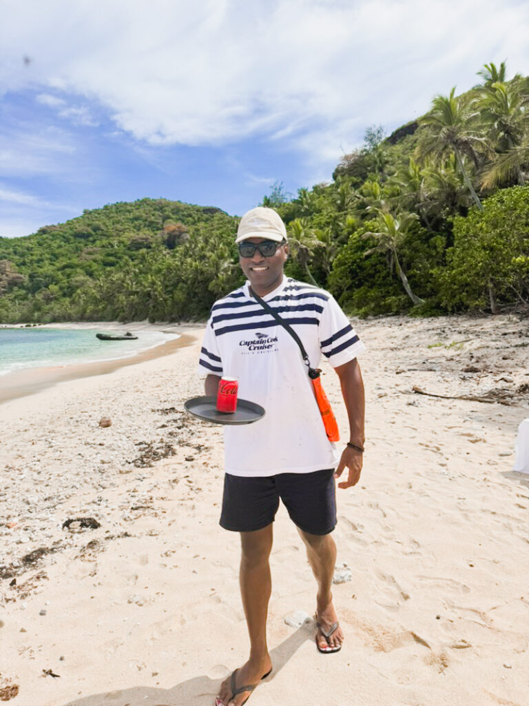 Captain Cook Cruises Fiji crew member Tim serving drinks on the island